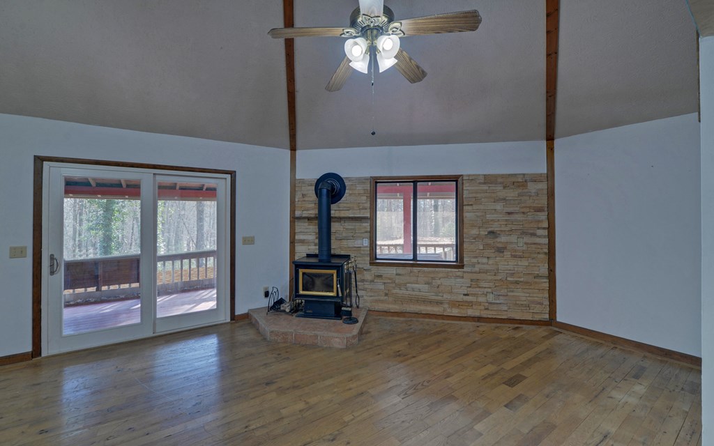 15 Trails End Road Blue Ridge, GA 30513 - Photo 6 of 46 a view of empty room with wooden floor and fan