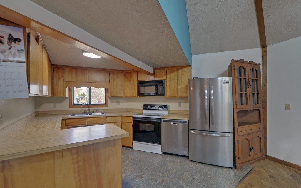 15 Trails End Road Blue Ridge, GA 30513 - Photo 9 of 46 a kitchen with stainless steel appliances granite countertop a refrigerator a stove a sink dishwasher and a microwave oven with cabinets