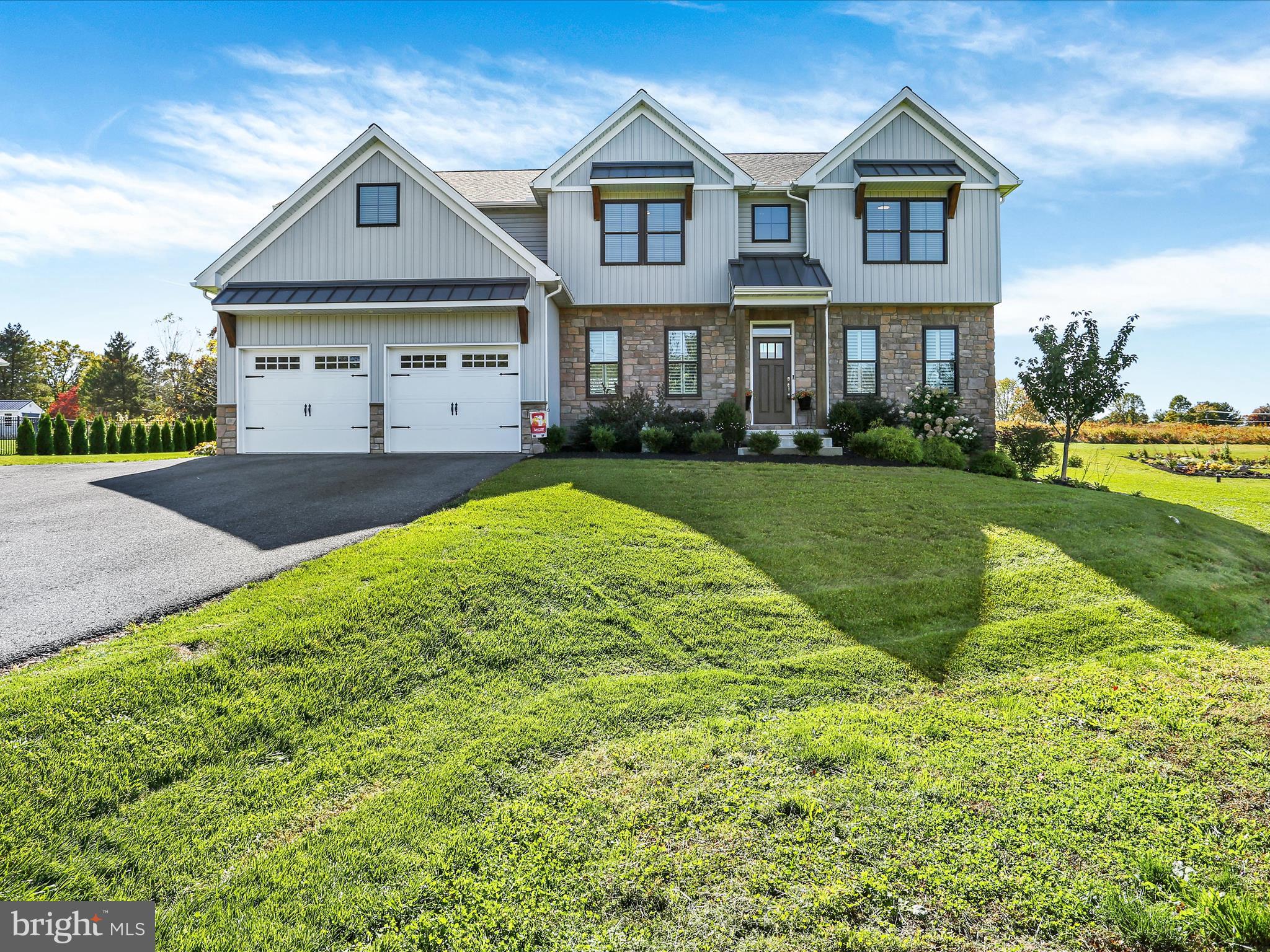 a front view of a house with a yard and porch