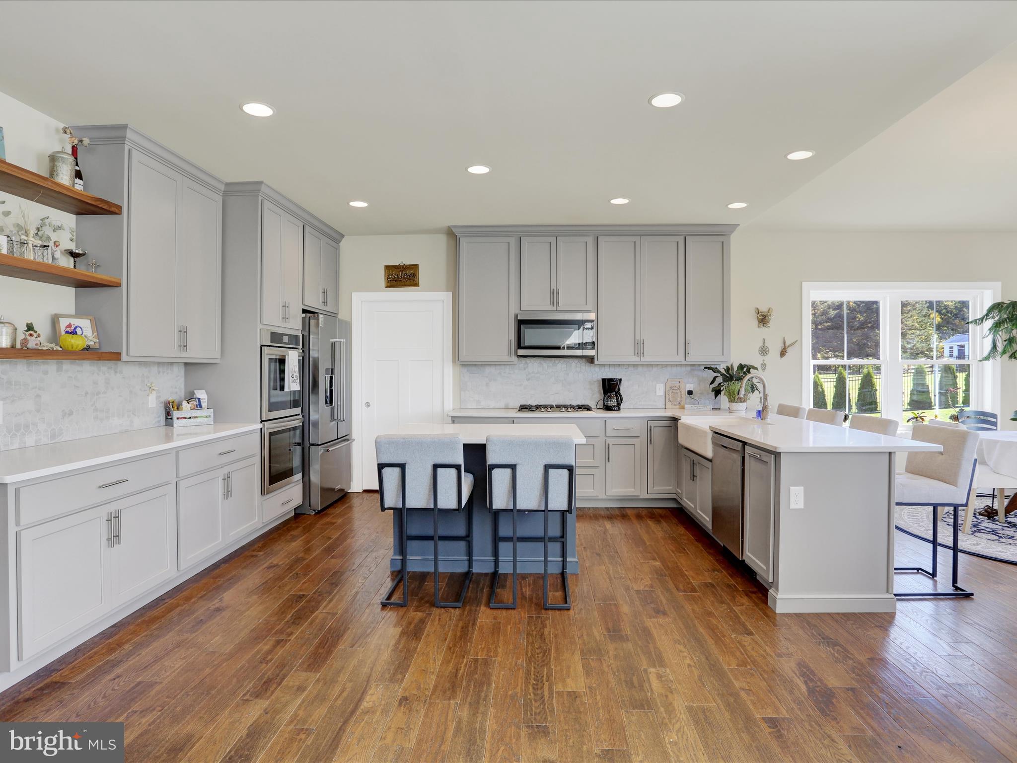 344 Hampshire Road Reading, PA 19608 - Photo 11 of 43 a kitchen with wooden floors and white stainless steel appliances