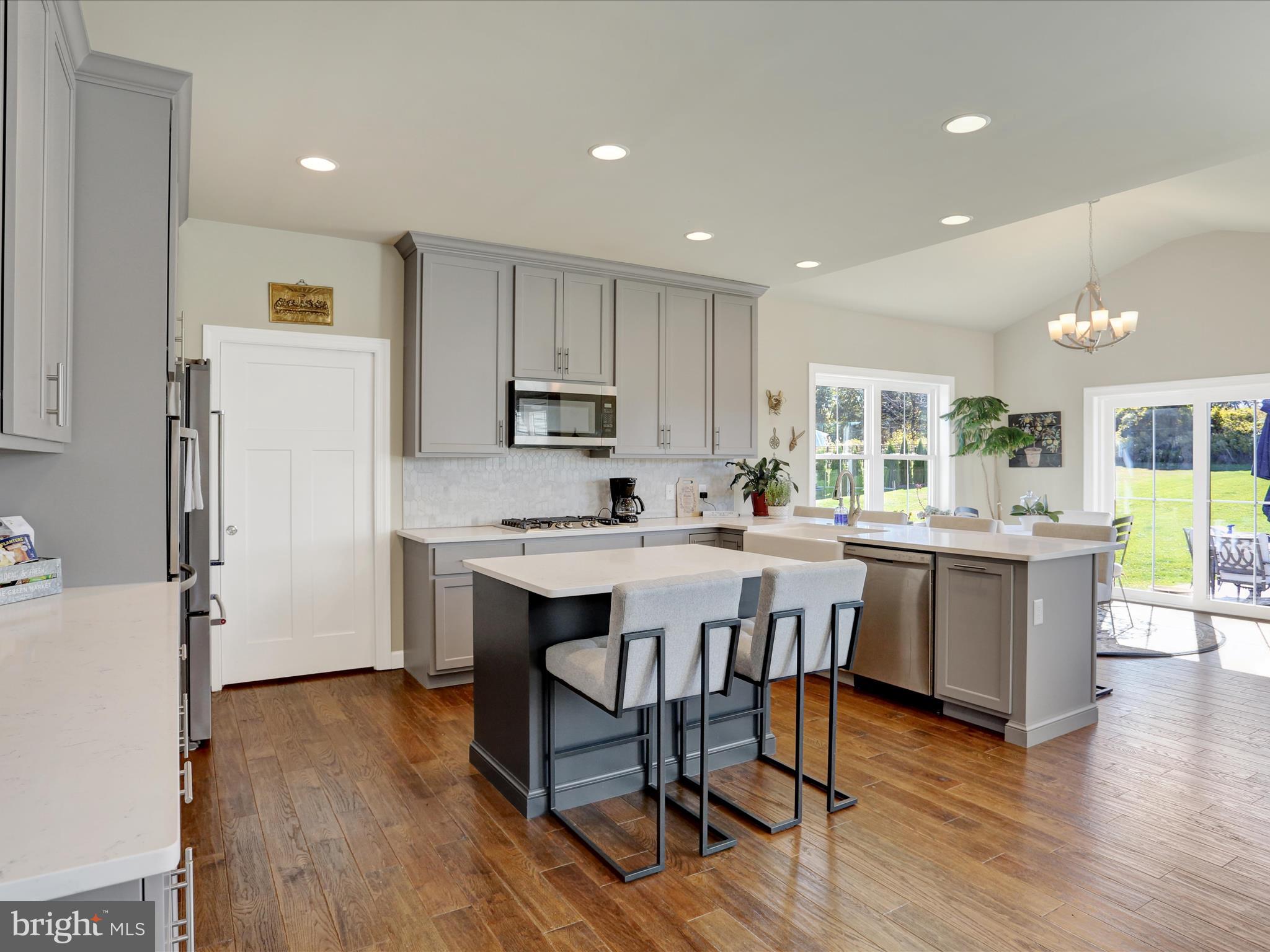 344 Hampshire Road Reading, PA 19608 - Photo 12 of 43 a kitchen with a table chairs refrigerator and microwave