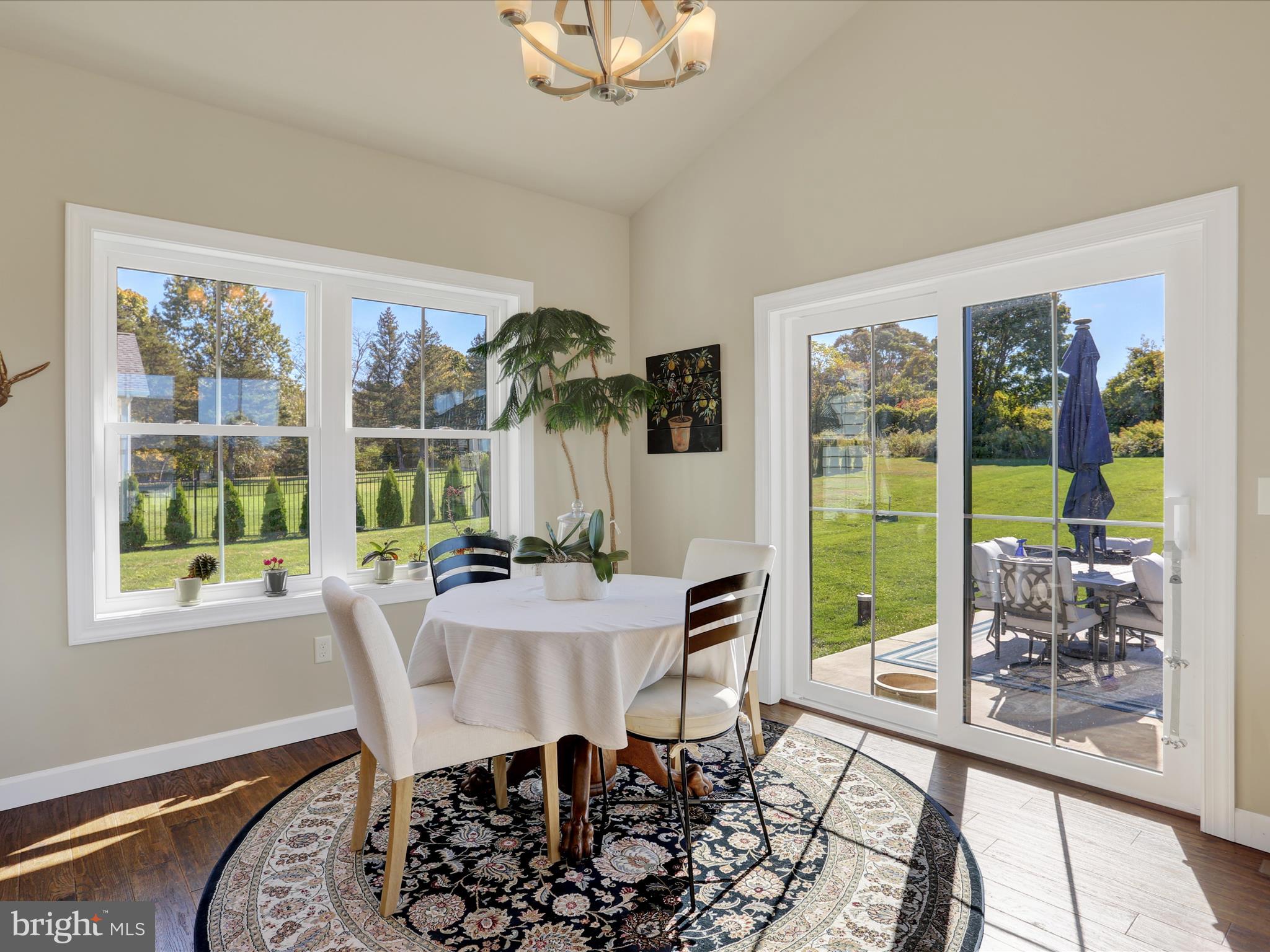 344 Hampshire Road Reading, PA 19608 - Photo 14 of 43 a dining room with furniture a rug and a floor to ceiling window