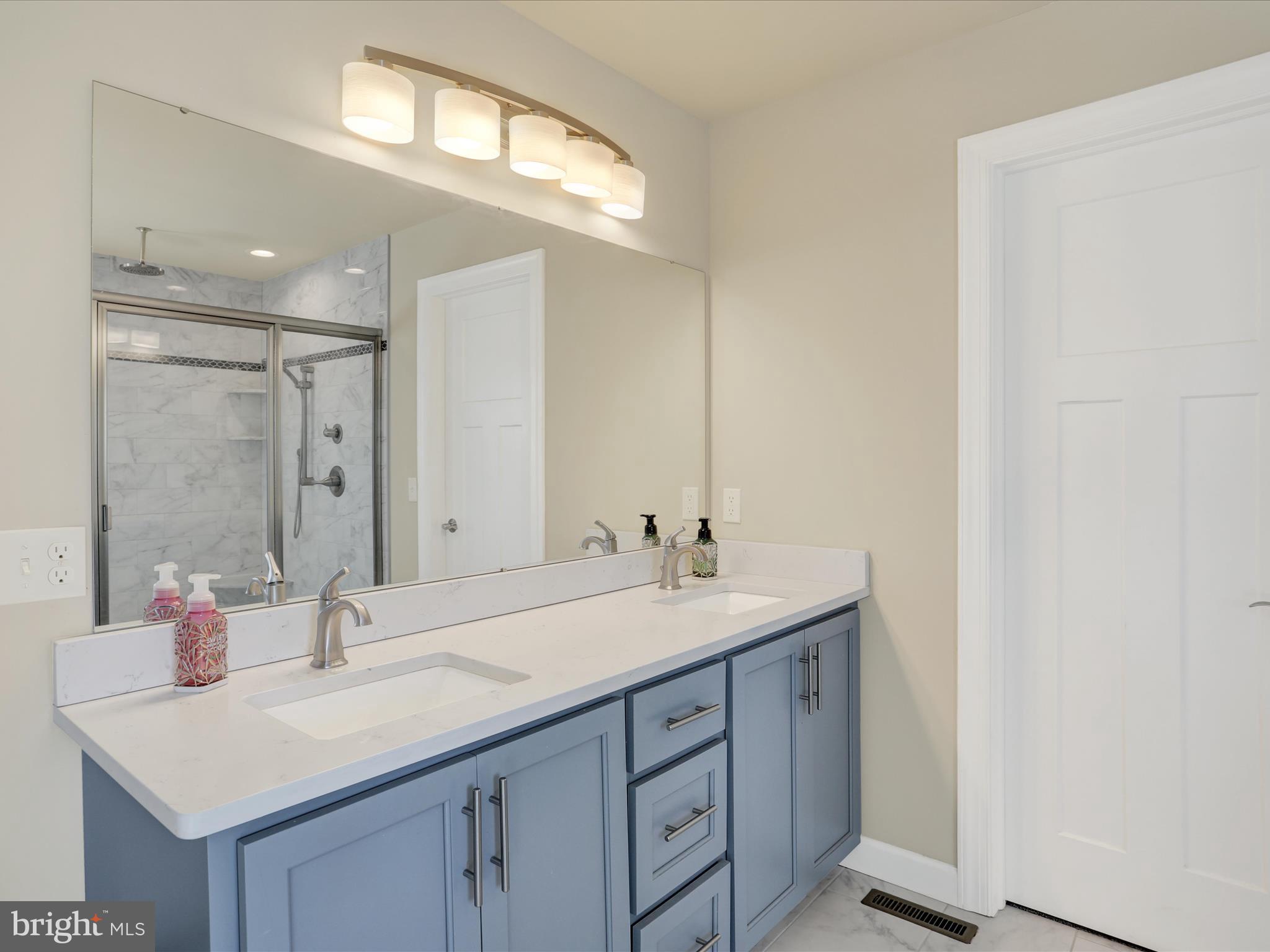 344 Hampshire Road Reading, PA 19608 - Photo 28 of 43 a bathroom with a sink vanity granite and a mirror