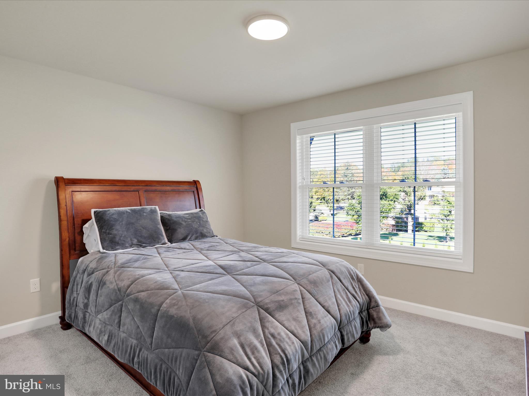 344 Hampshire Road Reading, PA 19608 - Photo 32 of 43 a large bed sitting in a bedroom next to a window