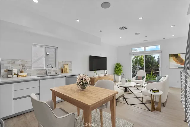 a living room with furniture a flat screen tv and a large window