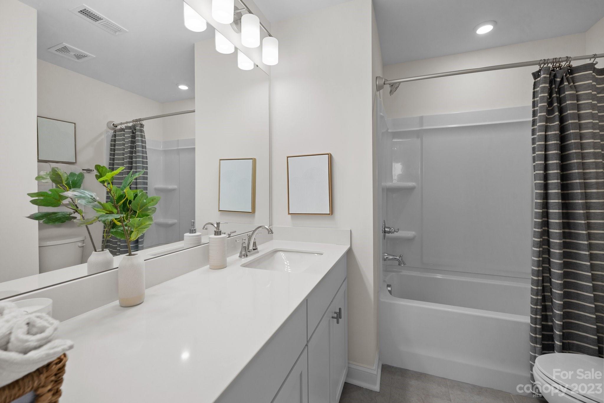 1057 South Point Road, Unit 22 Belmont, NC 28012 - Photo 11 of 19 a bathroom with a bathtub a sink and a large mirror