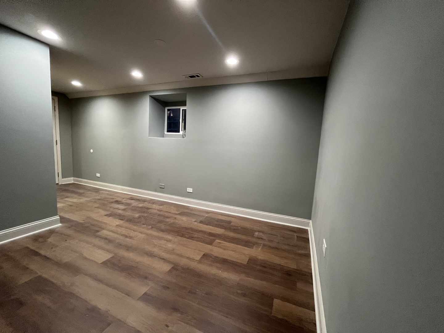 1446 West Irving Park Road, Unit 1 Chicago, IL 60613 - Photo 24 of 24 an empty room with wooden floor and windows