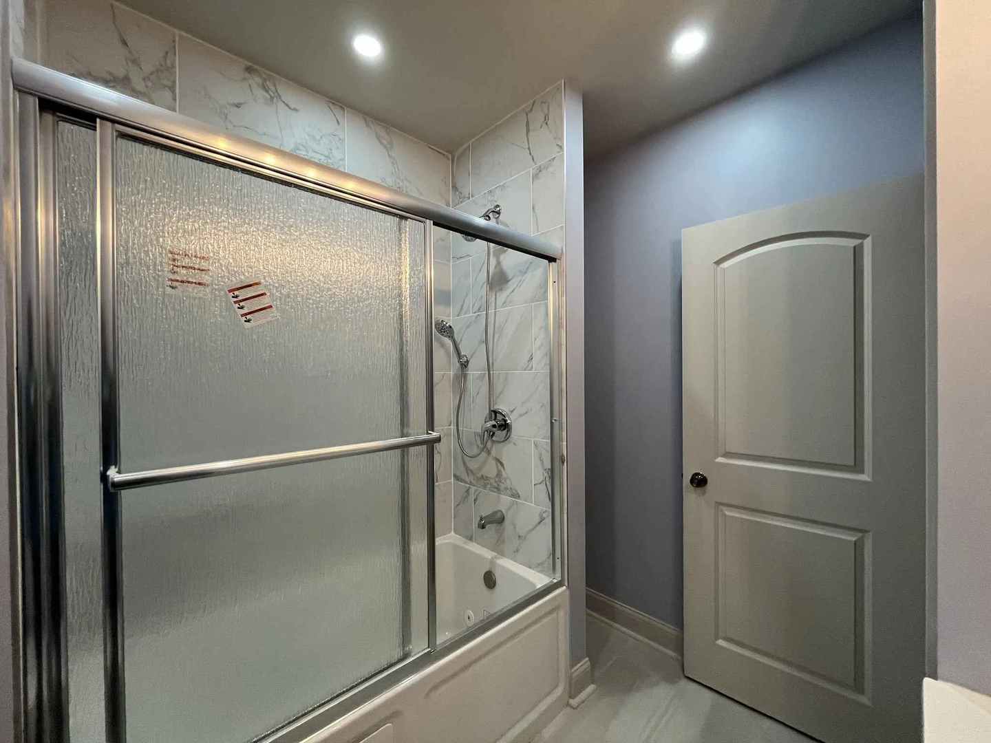 1446 West Irving Park Road, Unit 1 Chicago, IL 60613 - Photo 29 of 45 a bathroom with a bathtub and a shower