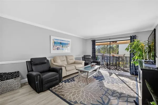 a living room with furniture large window and a flat screen tv