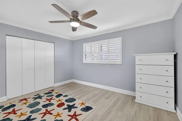 a view of a livingroom with wooden floor and a ceiling fan