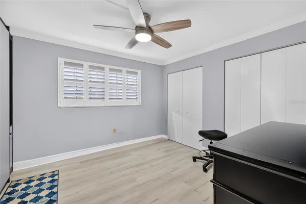 a room with gym equipment on the wall and a window
