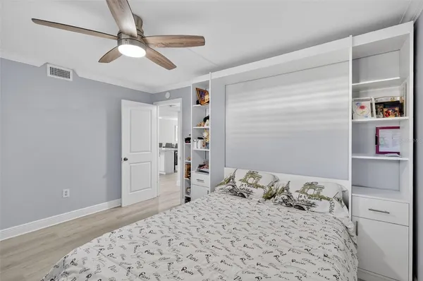a bedroom with a large bed and a chandelier