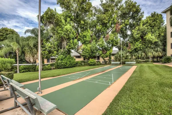 a view of a big building with a big yard and large trees