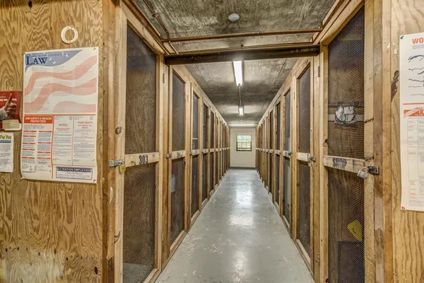 a large white kitchen with a large window and kitchen view