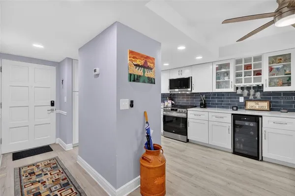 a kitchen with a refrigerator and a stove top oven