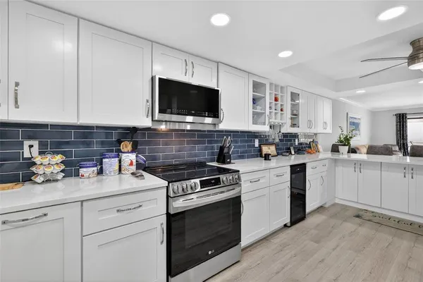 a kitchen with a stove a sink and a microwave