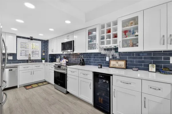 a kitchen with a sink stove and cabinets