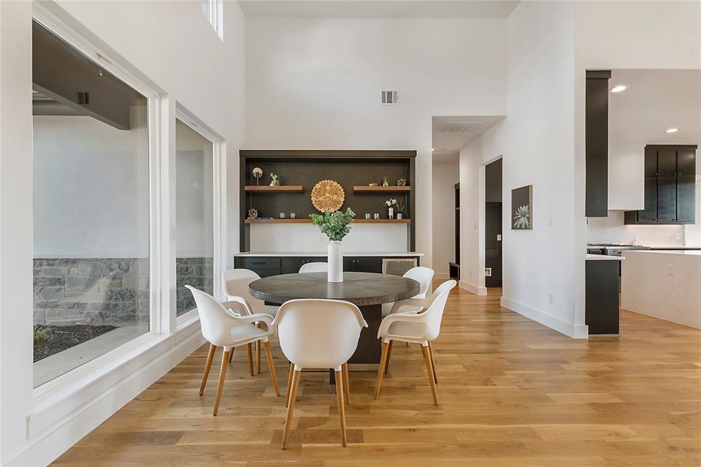 430 Whispering Way Red Oak, TX 75154 - Photo 12 of 40 Open-concept dining area featuring soaring ceilings and wood-finish flooring
