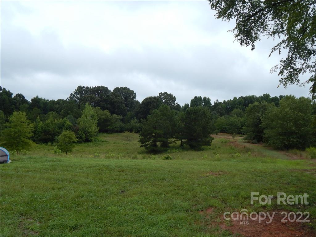 5312 Davis Road, Unit A Waxhaw, NC 28173 - Photo 11 of 12 a view of a field of grass and trees