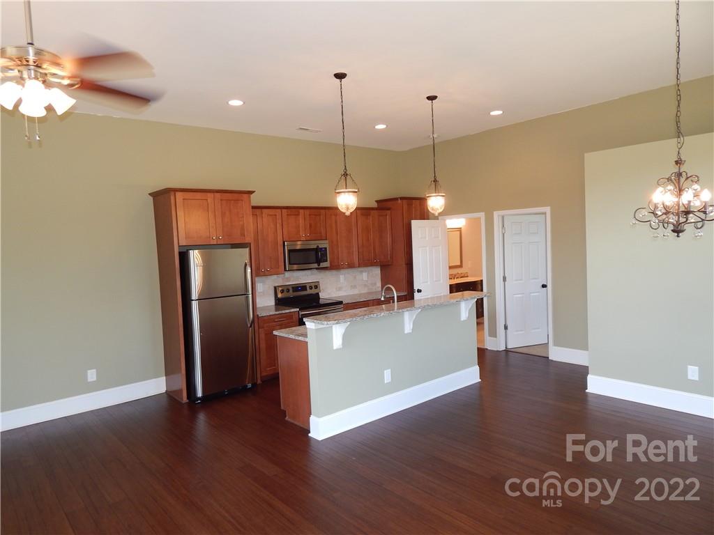 5312 Davis Road, Unit A Waxhaw, NC 28173 - Photo 2 of 12 a view of a kitchen with a sink refrigerator and wooden floor