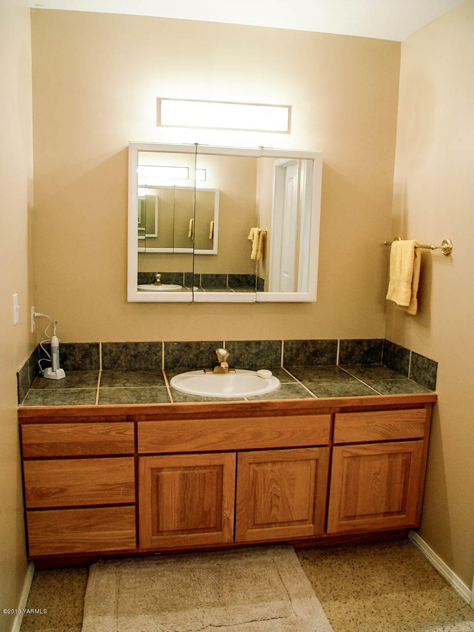 531 Winchester Road Yakima, WA 98908 - Photo 24 of 35 a bathroom with a granite countertop sink and a mirror