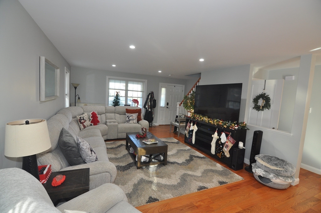 47 Maple Street, Unit A Middleton, MA 01949 - Photo 13 of 29 a living room with furniture and a flat screen tv