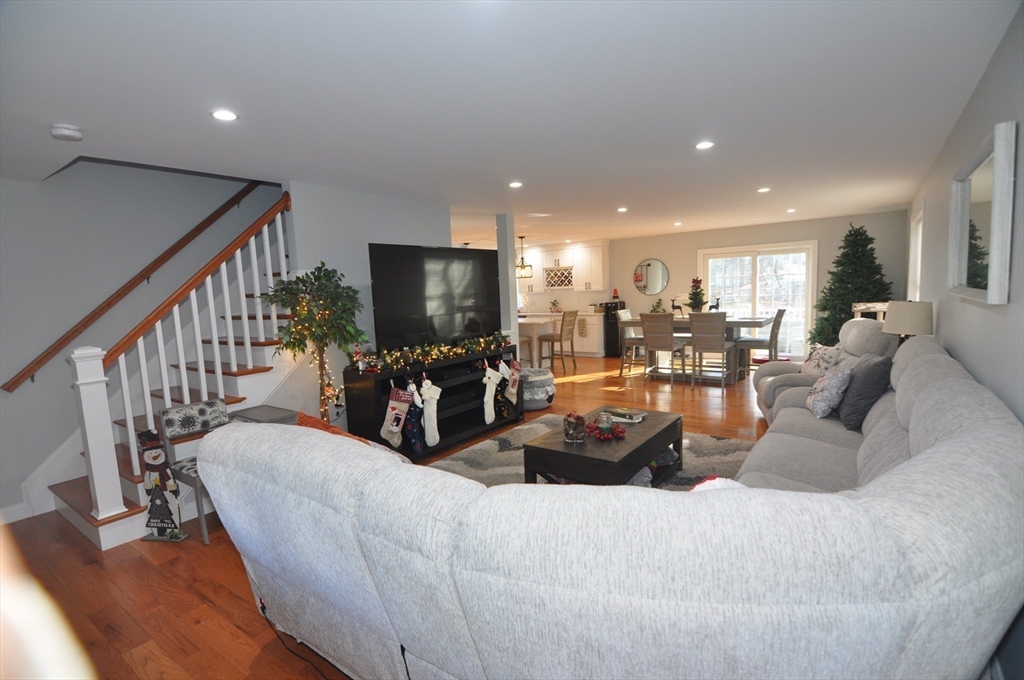 47 Maple Street, Unit A Middleton, MA 01949 - Photo 14 of 29 a living room with furniture kitchen view and a large window