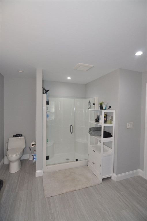 47 Maple Street, Unit A Middleton, MA 01949 - Photo 22 of 29 a bathroom with a shower and a toilet