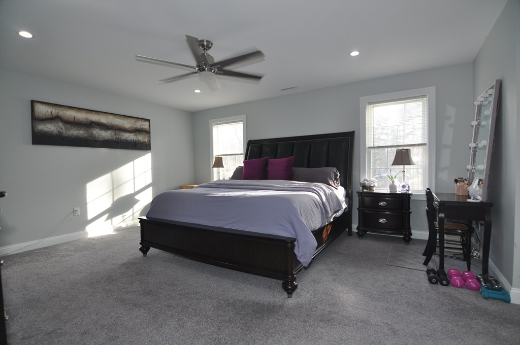 47 Maple Street, Unit A Middleton, MA 01949 - Photo 24 of 29 a spacious bedroom with a bed and a window
