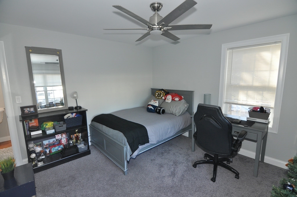 47 Maple Street, Unit A Middleton, MA 01949 - Photo 25 of 29 a bedroom with a bed and a window