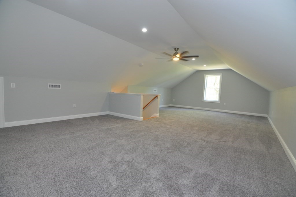 47 Maple Street, Unit A Middleton, MA 01949 - Photo 28 of 29 an empty room with windows and ceiling fan