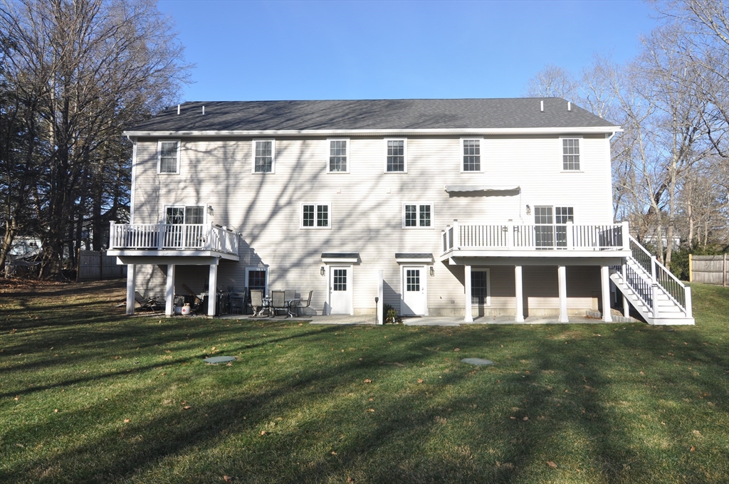 47 Maple Street, Unit A Middleton, MA 01949 - Photo 3 of 29 a front view of residential houses with yard and green space