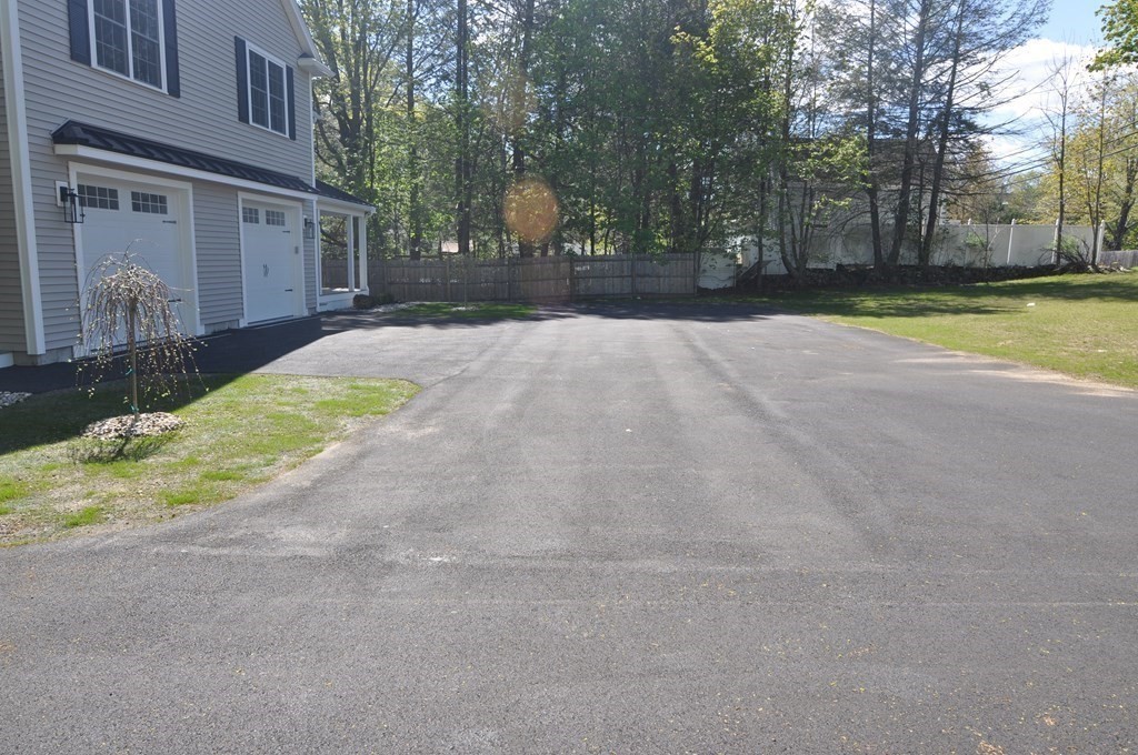 47 Maple Street, Unit A Middleton, MA 01949 - Photo 5 of 29 a view of a backyard with a large tree