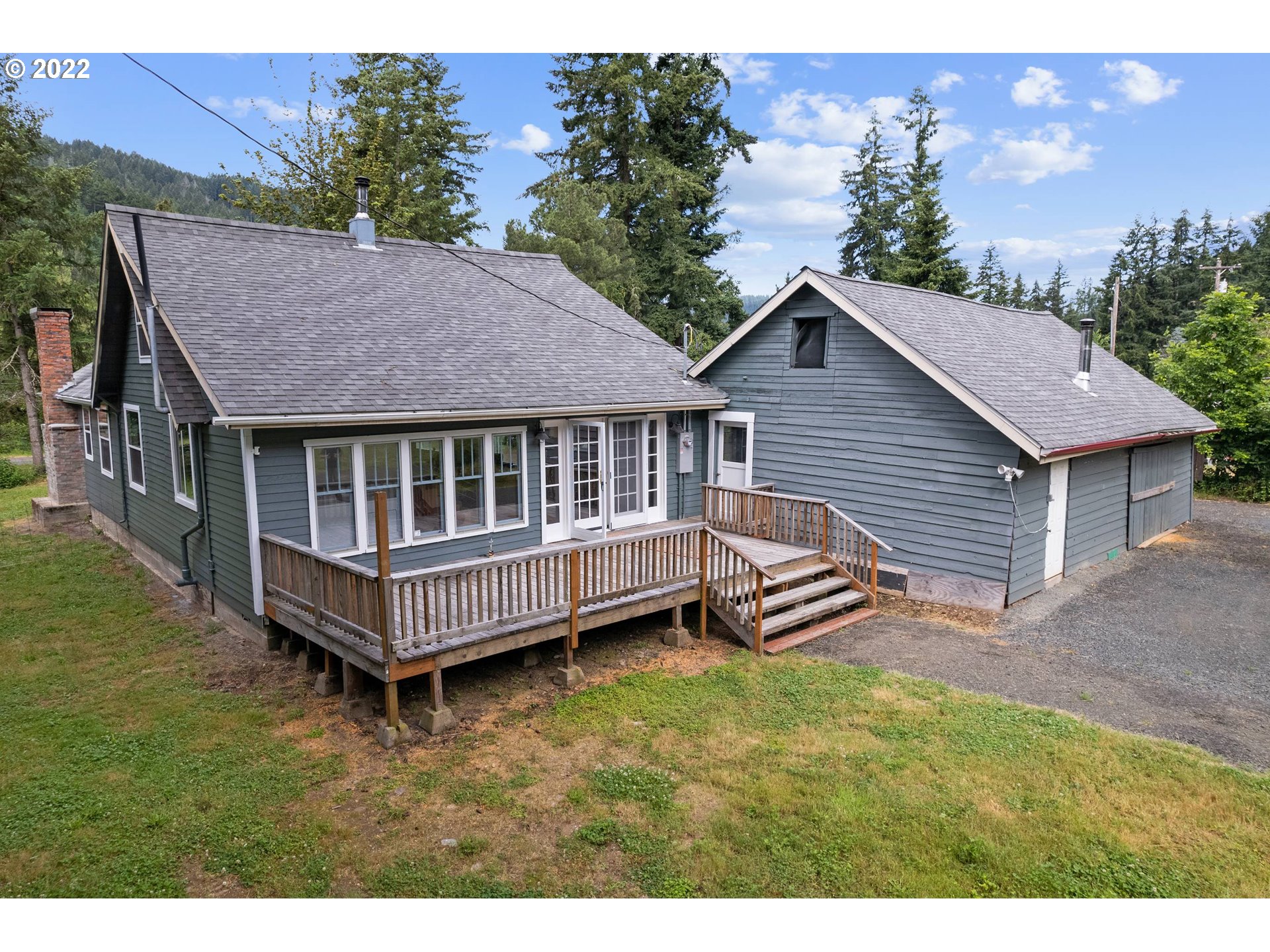 37863 Row River Road Dorena, OR 97434 - Photo 23 of 25 a view of a house with a garden and deck