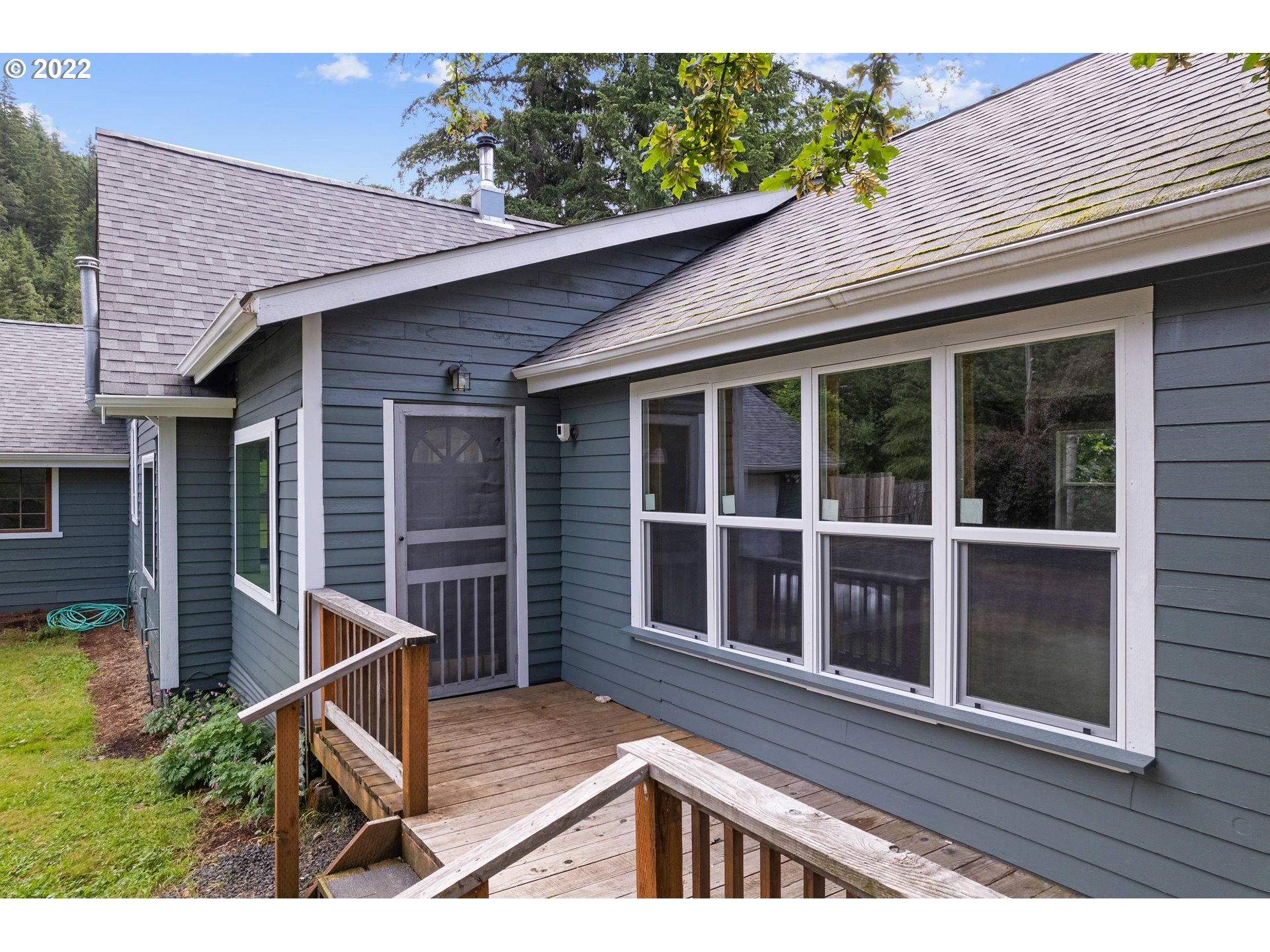 37863 Row River Road Dorena, OR 97434 - Photo 5 of 25 a view of house with a large window and wooden fence