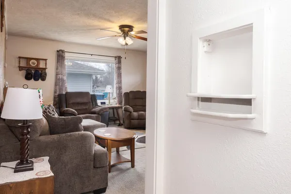 a living room with furniture and a lamp