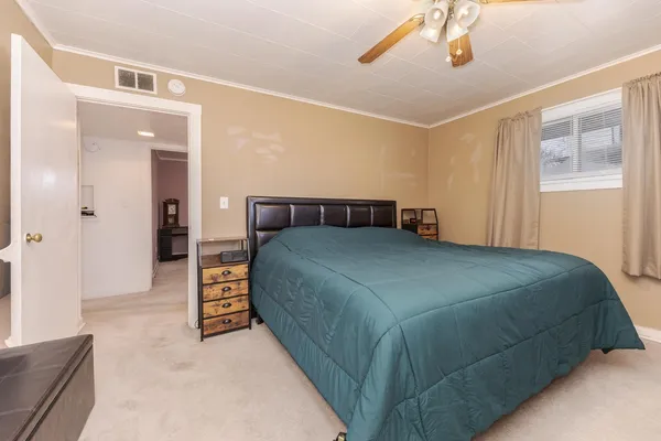 a bedroom with a bed and a chandelier