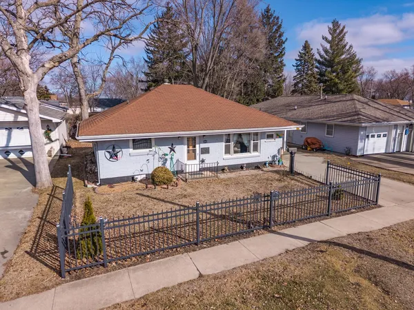 a view of a house with wooden fence