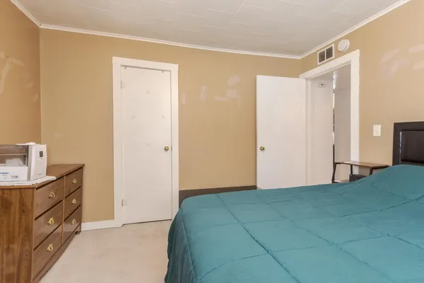 a bedroom with a bed and a sink
