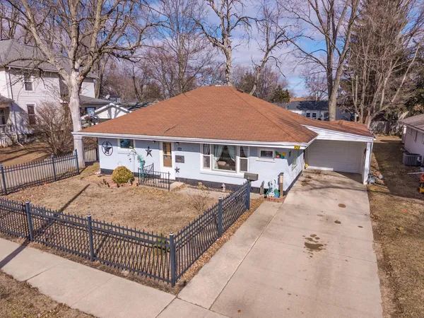 front view of a house with yard and sitting area