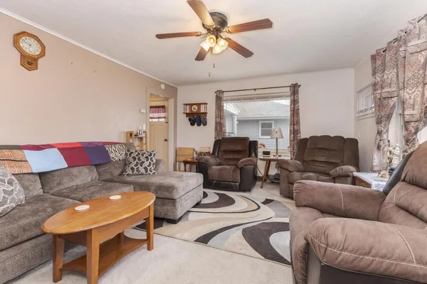 a living room with furniture and a chandelier