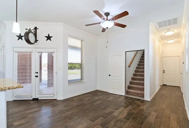 a kitchen with stainless steel appliances granite countertop a refrigerator a stove and a sink with wooden floor