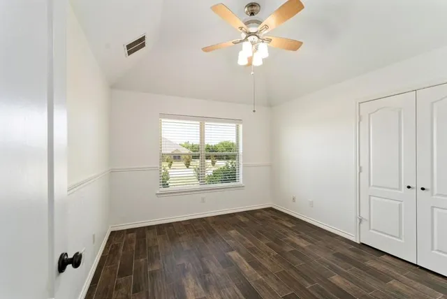 a bedroom with a bed couch and window