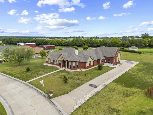 an aerial view of residential houses with outdoor space and river