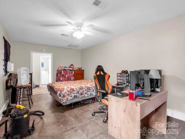 a bedroom with bed and a chandelier