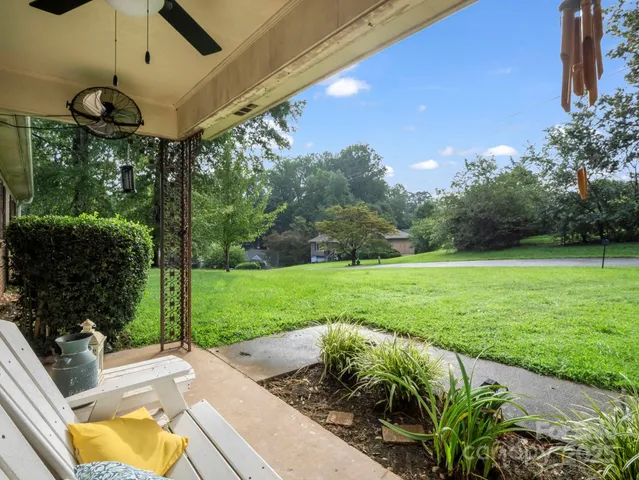 a view of a porch with furniture and garden