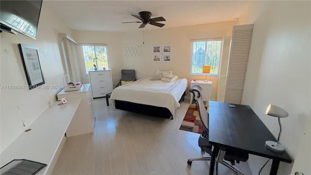 a bedroom with a bed window and table