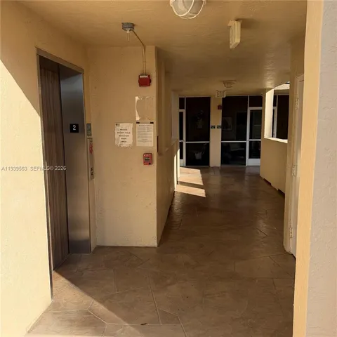 a view of a hallway with wooden shelves