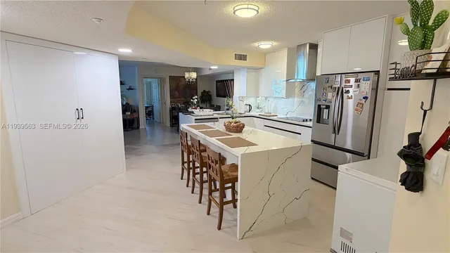 a kitchen with a refrigerator a sink and a stove top oven
