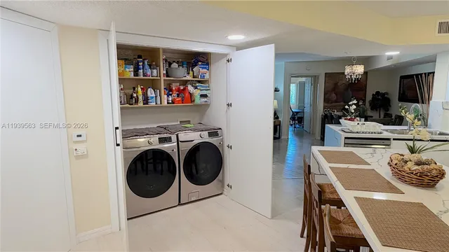 a view of a dining room with furniture and a kitchen